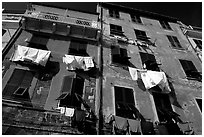 Typical terra cotta facade with clothelines and green shutters,  Vernazza. Cinque Terre, Liguria, Italy ( black and white)