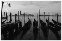 Parked gondolas, Canale della Guidecca, San Giorgio Maggiore church at dawn. Venice, Veneto, Italy ( black and white)
