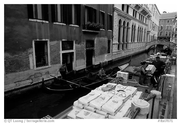 Delivery through a little canal. Venice, Veneto, Italy (black and white)