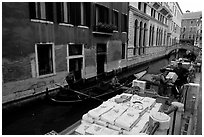 Delivery through a little canal. Venice, Veneto, Italy (black and white)