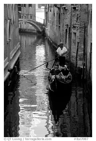 Gondola and reflections in a narrow canal. Venice, Veneto, Italy