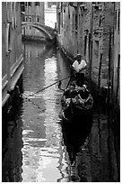 Gondola and reflections in a narrow canal. Venice, Veneto, Italy ( black and white)