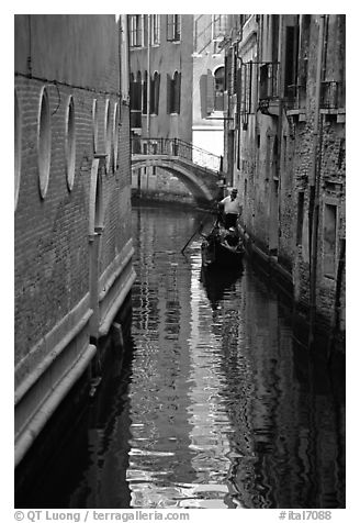 Gondola and reflections in a narrow canal. Venice, Veneto, Italy