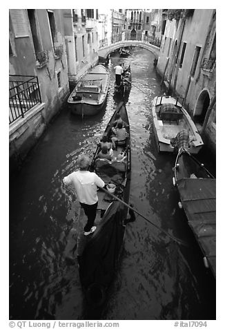 Gondolas lined up in narrow canal. Venice, Veneto, Italy (black and white)