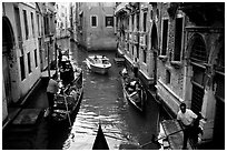 Busy water trafic in  narrow canal. Venice, Veneto, Italy (black and white)