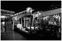 Gondolier and gondola, Rialto Bridge at night. Venice, Veneto, Italy (black and white)