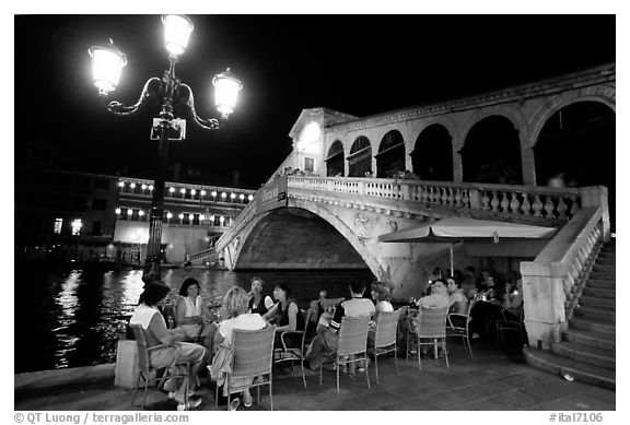 Outdoor cafe terrace,  Rialto Bridge at night. Venice, Veneto, Italy (black and white)