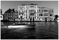 Water taxi passes in front of the Palazzo Dorio on the Grand Canal. Venice, Veneto, Italy (black and white)