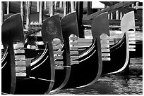 Row of gondolas prows, with their characteristic ferri. Venice, Veneto, Italy (black and white)