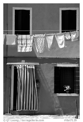 Hanging laundry and colored wall, Burano. Venice, Veneto, Italy (black and white)