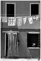 Hanging laundry and colored wall, Burano. Venice, Veneto, Italy (black and white)