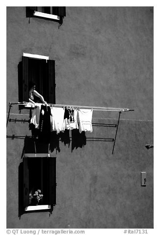 Windows, hanging laundry, blue house, Burano. Venice, Veneto, Italy (black and white)