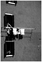 Windows, hanging laundry, blue house, Burano. Venice, Veneto, Italy (black and white)