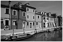 Canal bordered by colorfully painted houses, Burano. Venice, Veneto, Italy (black and white)