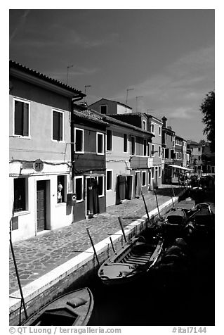 Canal lined with houses painted with bright colors, Burano. Venice, Veneto, Italy (black and white)