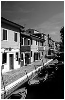 Canal lined with houses painted with bright colors, Burano. Venice, Veneto, Italy (black and white)