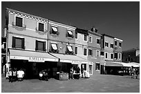 Street with brightly painted houses, Burano. Venice, Veneto, Italy (black and white)