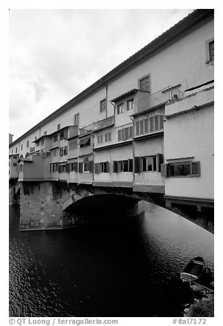Ponte Vecchio bridge covered with shops, spanning  Arno River. Florence, Tuscany, Italy (black and white)