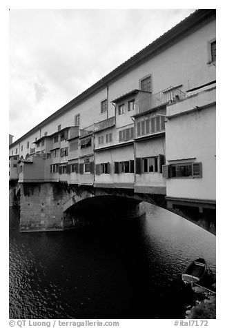 Ponte Vecchio bridge covered with shops, spanning  Arno River. Florence, Tuscany, Italy