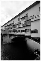 Ponte Vecchio bridge covered with shops, spanning  Arno River. Florence, Tuscany, Italy ( black and white)