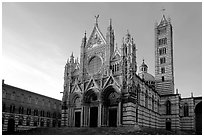 Siena Cathedral (Duomo) with bands of colored marble, late afternoon. Siena, Tuscany, Italy (black and white)