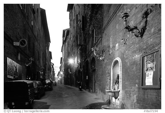 Street and fountain at dawn. Siena, Tuscany, Italy (black and white)