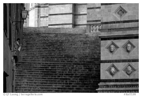 Woman cleaning up besides the Duomo stairs. Siena, Tuscany, Italy (black and white)