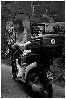 Delivering mail from a scooter. Siena, Tuscany, Italy ( black and white)