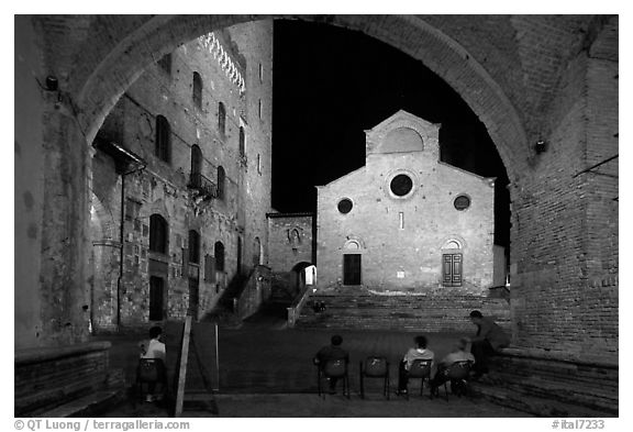 Duomo framed by an arch at night. San Gimignano, Tuscany, Italy (black and white)