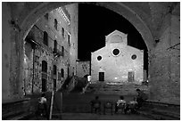 Duomo framed by an arch at night. San Gimignano, Tuscany, Italy ( black and white)