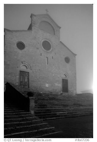 Duomo at dawn in the fog. San Gimignano, Tuscany, Italy (black and white)