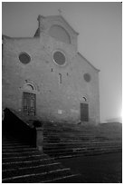 Duomo at dawn in the fog. San Gimignano, Tuscany, Italy ( black and white)