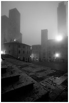 Piazza del Duomo at dawn in the fog. San Gimignano, Tuscany, Italy ( black and white)