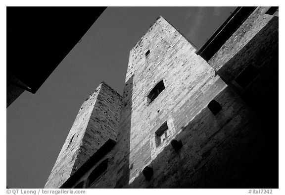 Medieval tower seen from the street, early morning. San Gimignano, Tuscany, Italy (black and white)