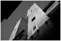 Medieval tower seen from the street, early morning. San Gimignano, Tuscany, Italy ( black and white)