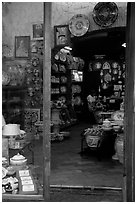 Woman painting plates in a ceramic store. Orvieto, Umbria (black and white)