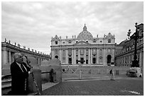 Pilgrim prays in front of the Basilic Saint Peter. Vatican City (black and white)