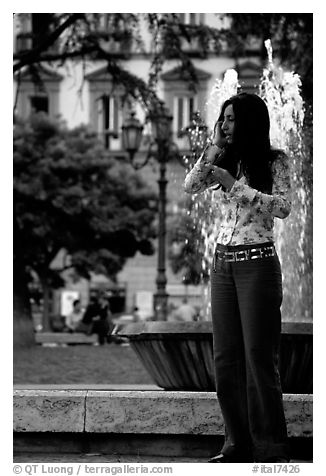 Young woman talking on a cell phone. Naples, Campania, Italy (black and white)