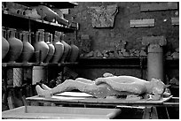 Artifacts found during the excavations, including a petrified man. Pompeii, Campania, Italy ( black and white)