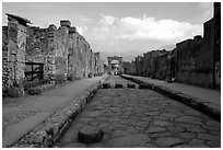Street with roman period pavement and sidewalks. Pompeii, Campania, Italy ( black and white)
