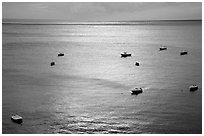 Small boats at sunset in the Gulf of Salerno, Positano. Amalfi Coast, Campania, Italy ( black and white)