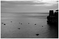 Small boats and tower and sunset, Positano. Amalfi Coast, Campania, Italy ( black and white)