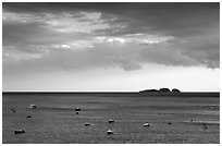 Small boats and Capri Island at sunset, Positano. Amalfi Coast, Campania, Italy ( black and white)