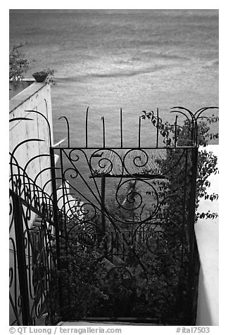 Forged metal entrance to a garden overlooking the sea, Positano. Amalfi Coast, Campania, Italy (black and white)