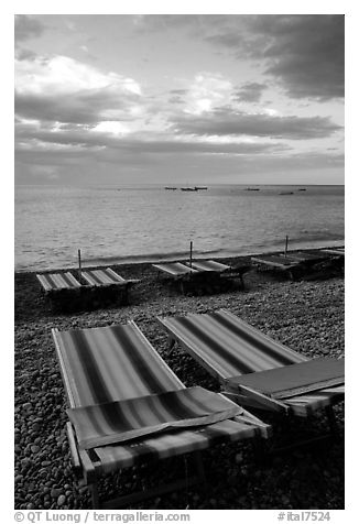 Beach chairs on Spiaggia del Fornillo at sunset, Positano. Amalfi Coast, Campania, Italy