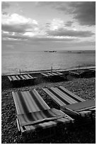 Beach chairs on Spiaggia del Fornillo at sunset, Positano. Amalfi Coast, Campania, Italy (black and white)