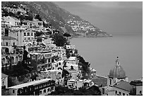 Chiesa di Santa Maria Assunta and houses on steep hills at dusk, Positano. Amalfi Coast, Campania, Italy ( black and white)