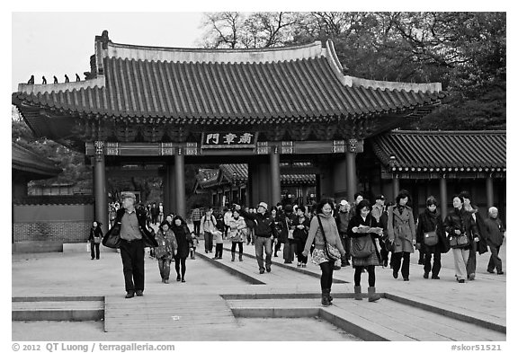 People walking down gate, Changdeok Palace. Seoul, South Korea (black and white)