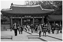 People walking down gate, Changdeok Palace. Seoul, South Korea (black and white)