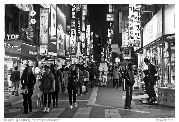 Shoppers on pedestrian street by night. Seoul, South Korea (black and white)